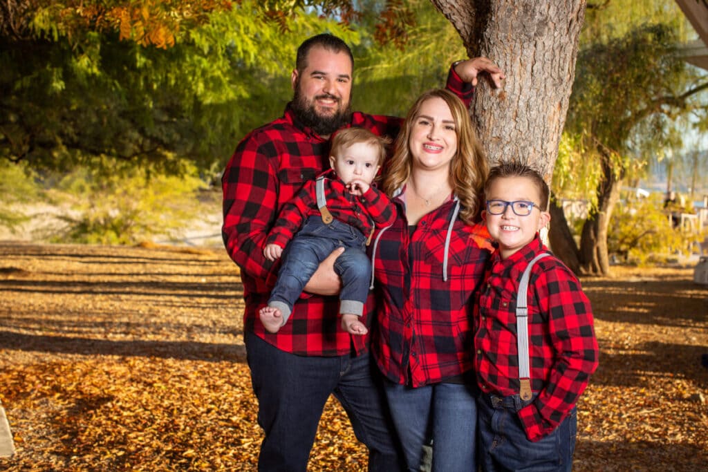 Family in plaid with fall leaves