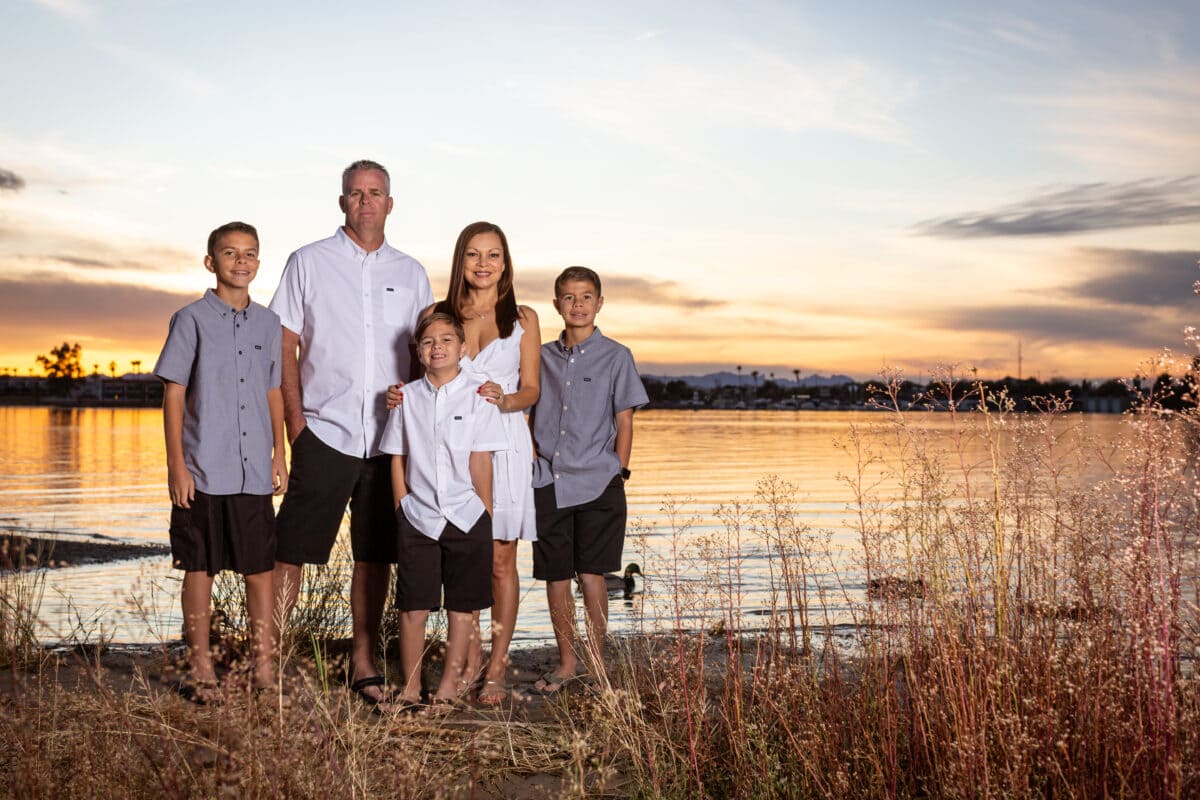 Colorful family photo at sunset by the lake on the beach